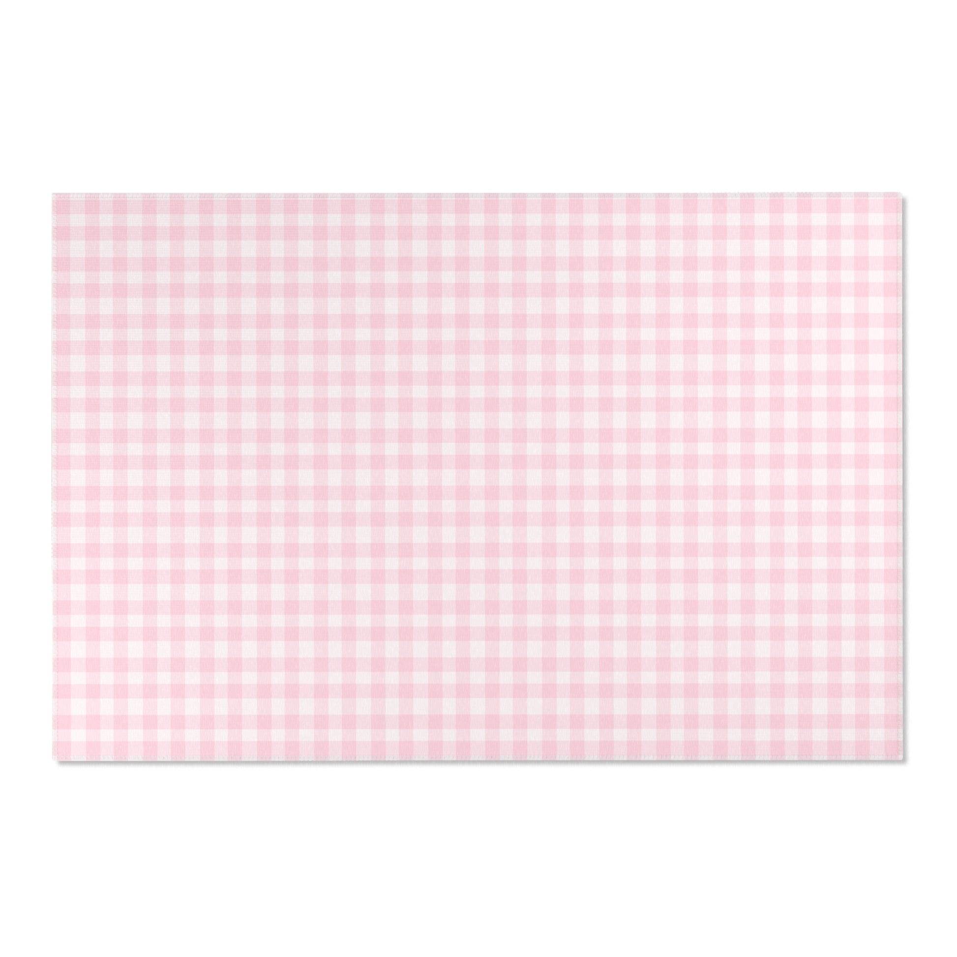 Soft pink check rug defining a nursery play area