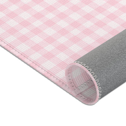 Pink gingham area rug in a baby nursery corner