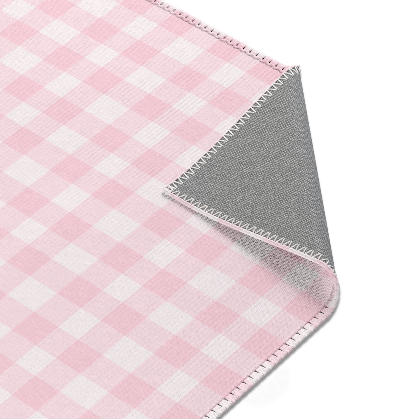 Blush Gingham rug seen from above in a nursery