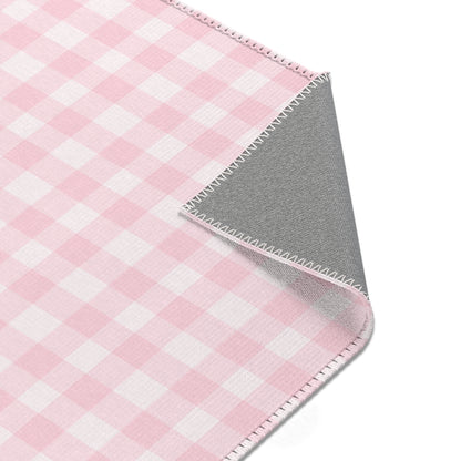 Blush Gingham rug seen from above in a nursery