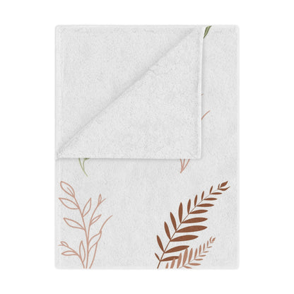 Boho Botanical minky baby blanket draped over a crib