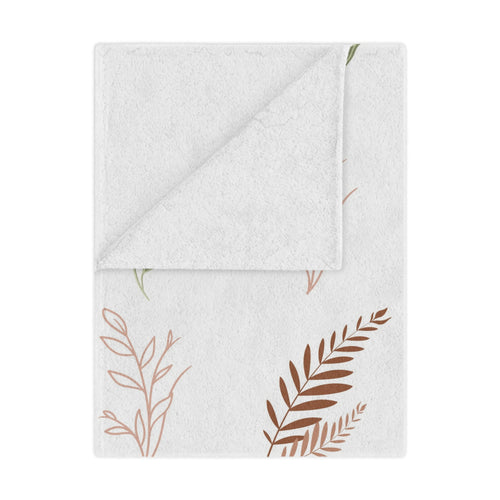 Boho Botanical minky baby blanket draped over a crib