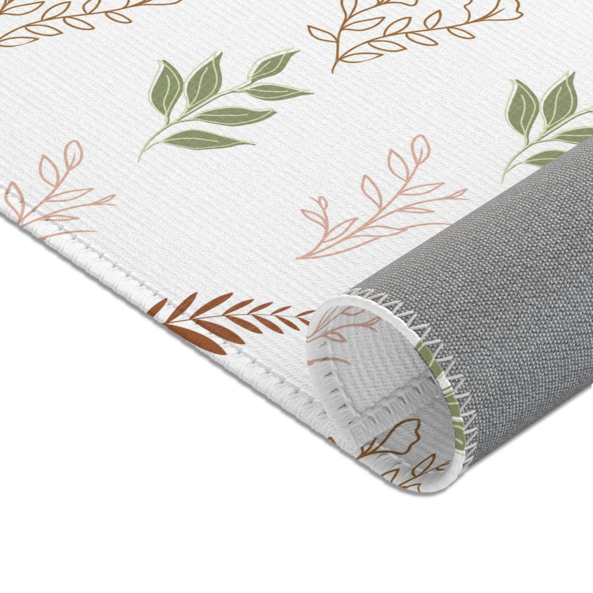 Fern and leaf sprigs printed across the nursery area rug