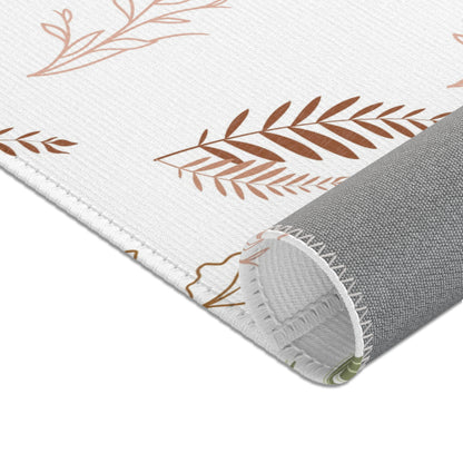 Nursery area rug in a neutral boho palette of sage and rust