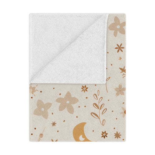 Celestial Bloom minky baby blanket draped over a crib