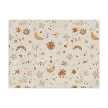 Close detail of the moon and daisy print on the minky blanket