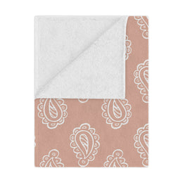 Clay Paisley minky baby blanket draped over a crib