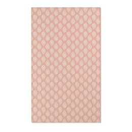 Paisley nursery area rug in cream on dusty clay rose