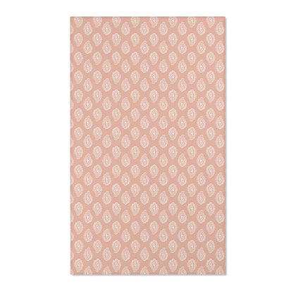 Paisley nursery area rug in cream on dusty clay rose