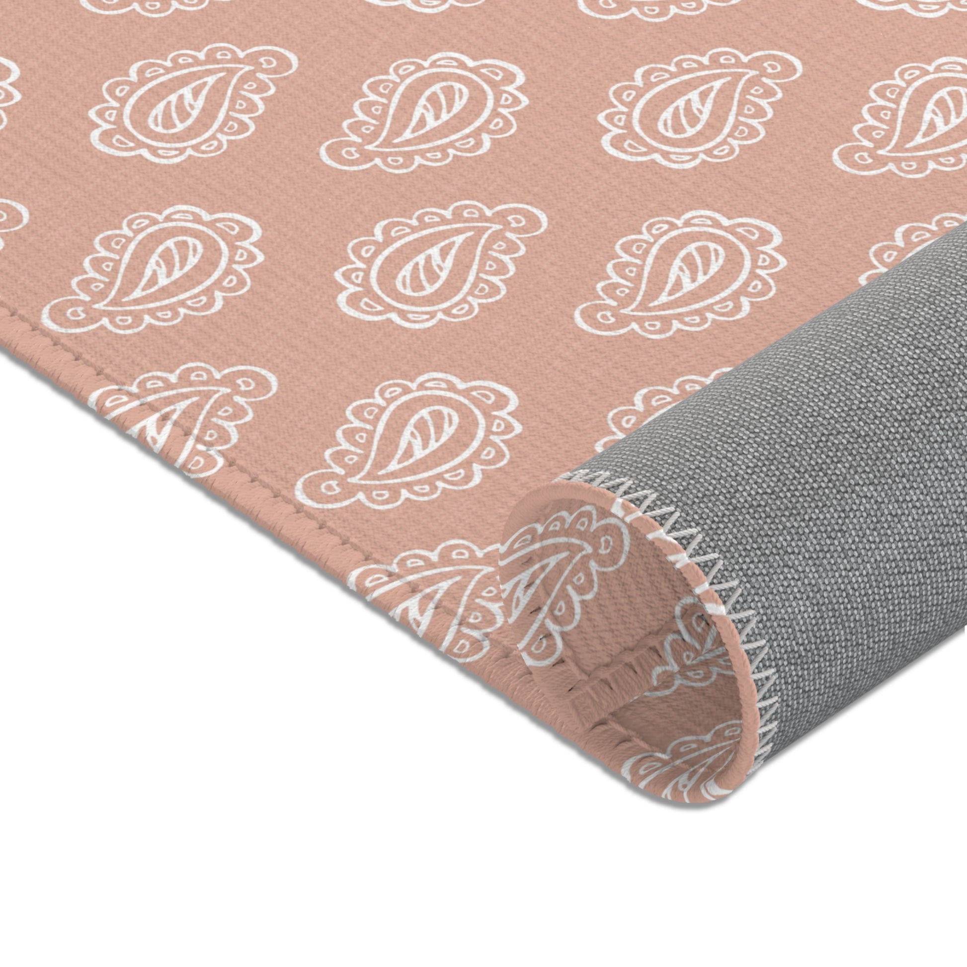 Rows of outlined paisley printed across the nursery area rug