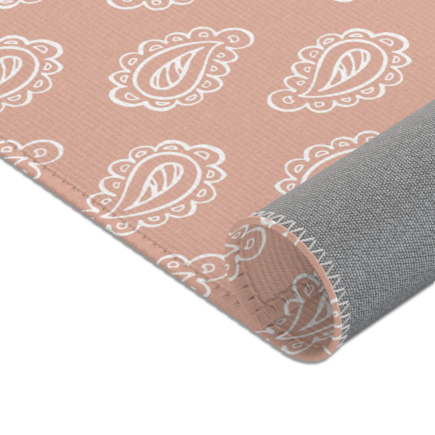 Nursery area rug in a warm clay rose and cream palette
