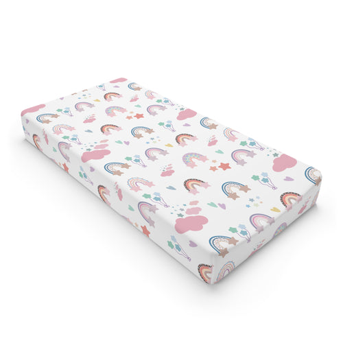 Confetti Rainbows changing pad cover on a nursery changing table
