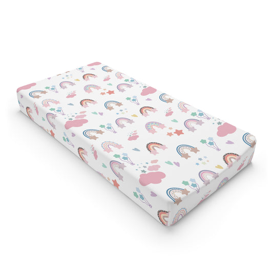 Confetti Rainbows changing pad cover on a nursery changing table