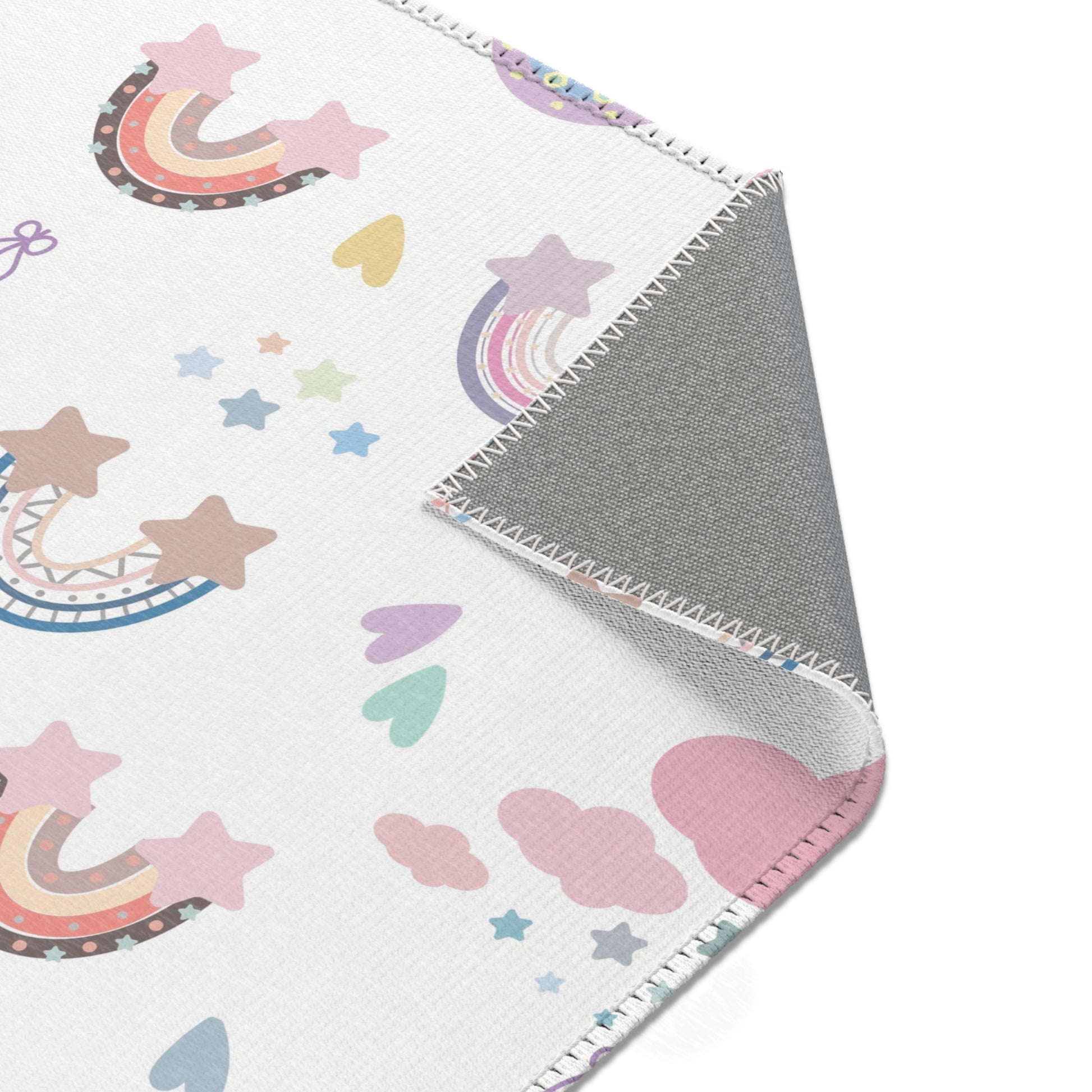 Nursery area rug printed edge to edge with pastel rainbows