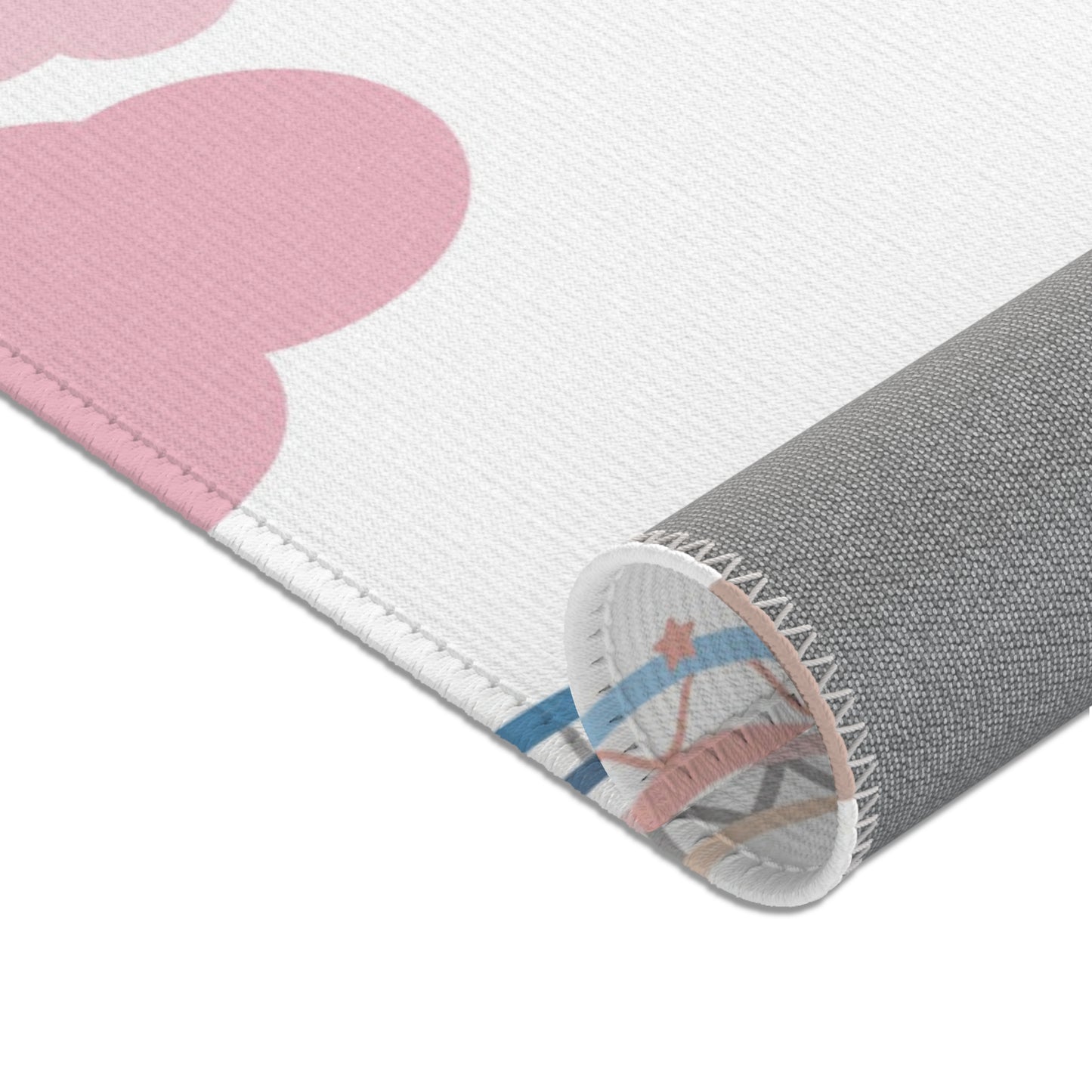 Corner detail of the Confetti Rainbows nursery area rug