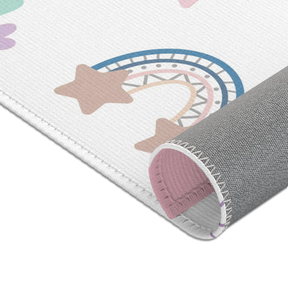Rainbows, stars and hearts printed across the nursery area rug