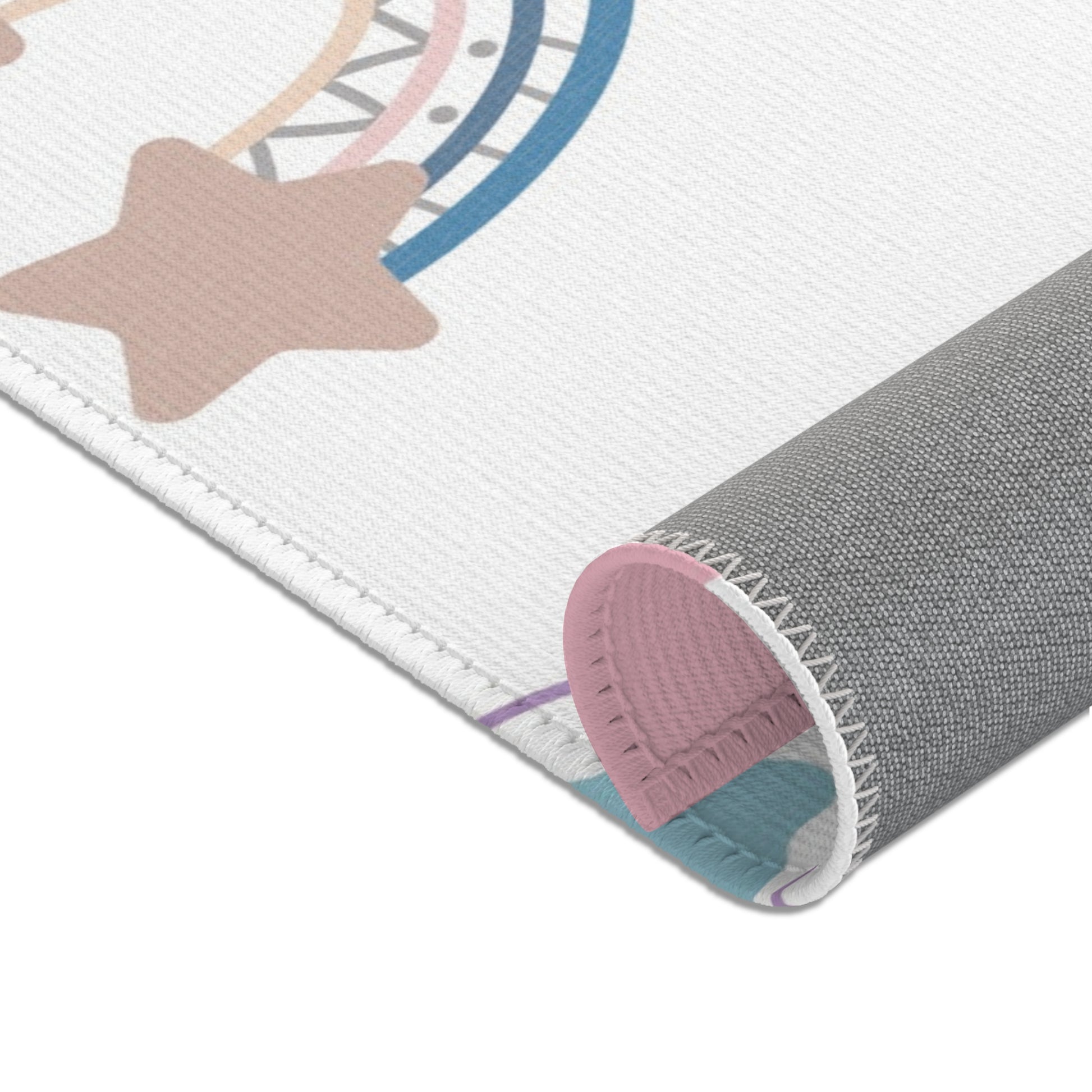 Nursery area rug in a pink, lilac and blue palette