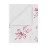 Crimson Bow minky baby blanket draped over a crib