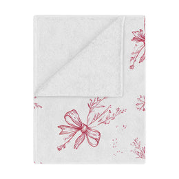 Crimson Bow minky baby blanket draped over a crib