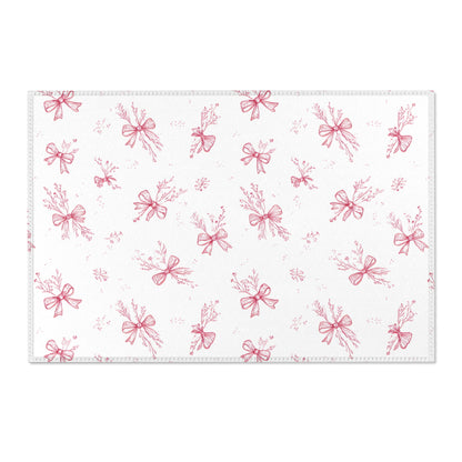 Toile bow print area rug beside a nursery crib