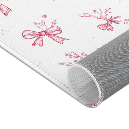 Toile bow area rug in a baby nursery corner