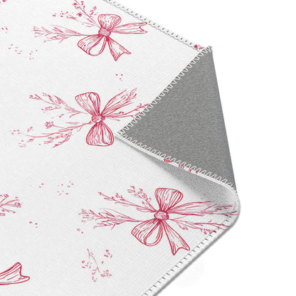Raspberry bow print rug in a small baby room