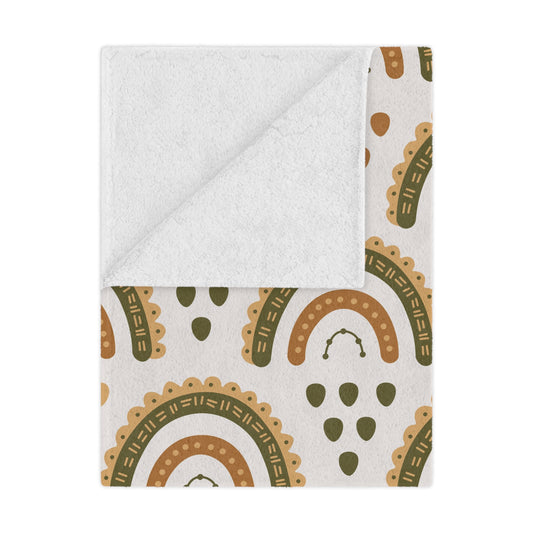 Desert Rainbow minky baby blanket draped over a crib