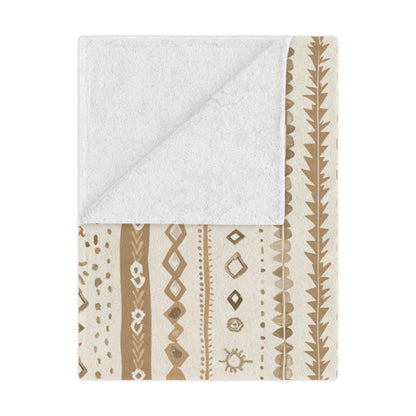 Desert Stripe minky baby blanket draped over a crib
