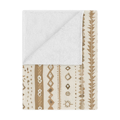 Desert Stripe minky baby blanket draped over a crib
