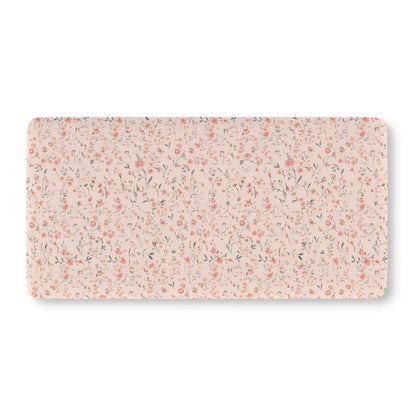 Fitted crib sheet with tiny coral flowers on blush