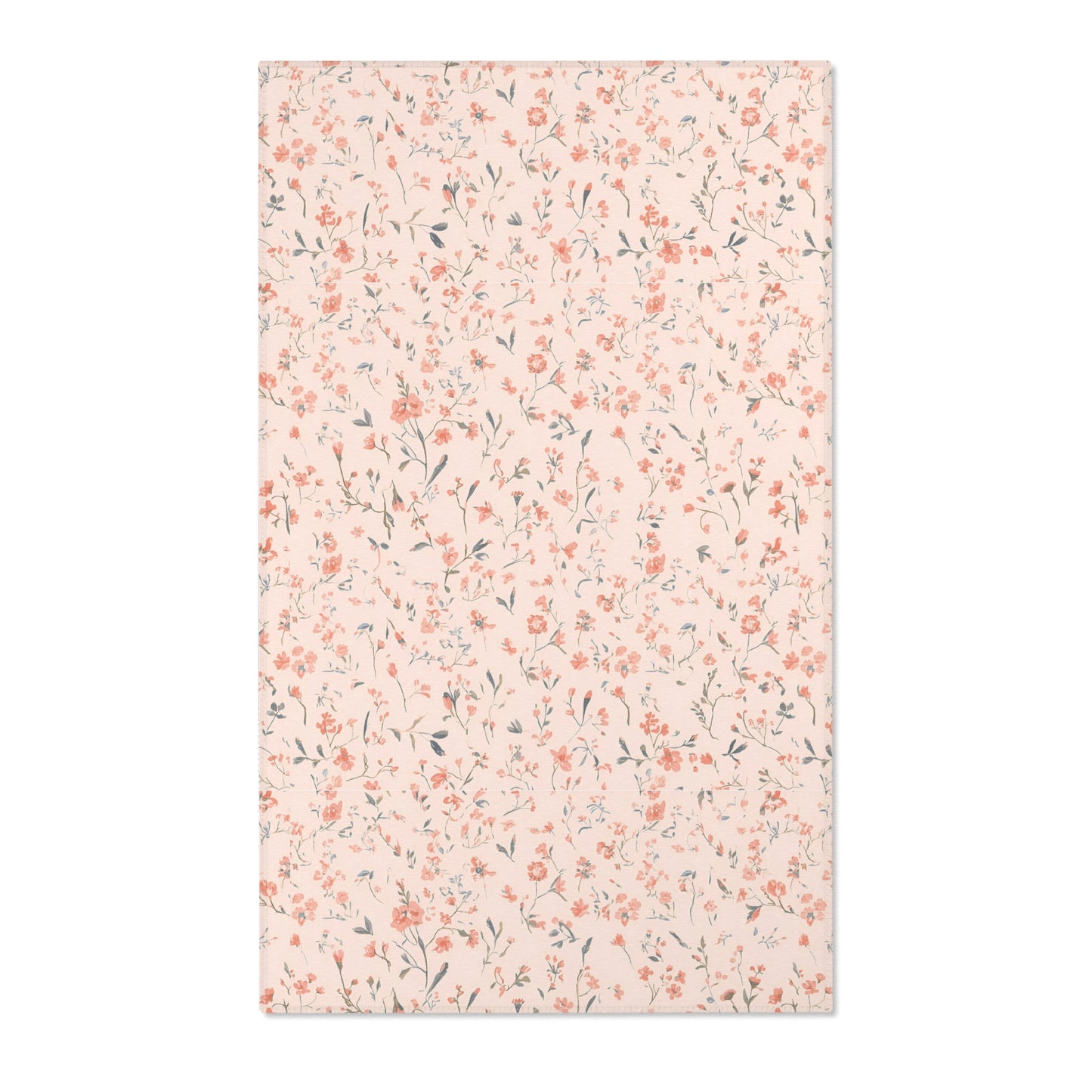 Small floral nursery area rug in coral on blush