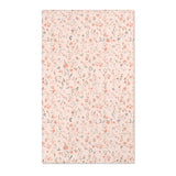 Small floral nursery area rug in coral on blush