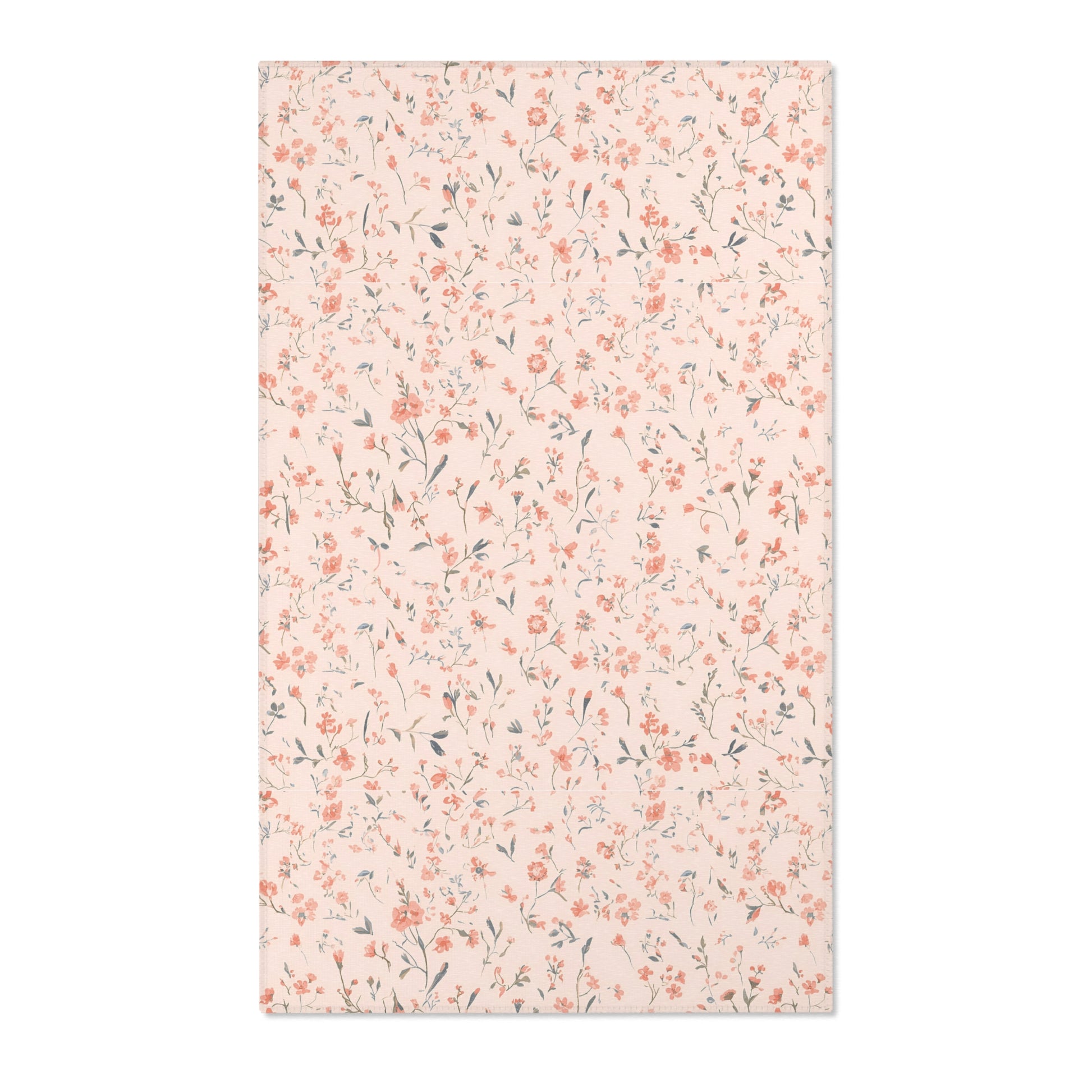 Small floral nursery area rug in coral on blush