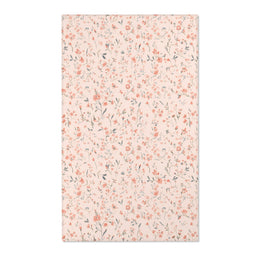 Small floral nursery area rug in coral on blush