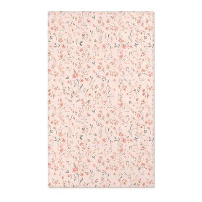 Small floral nursery area rug in coral on blush