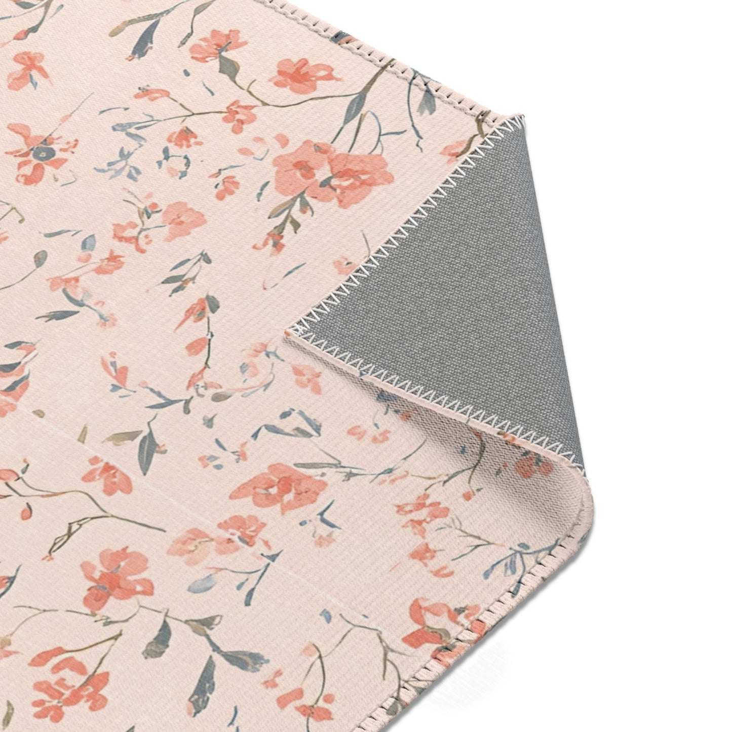 Ditsy floral rug in coral and blush for a nursery floor