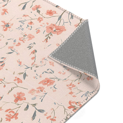Ditsy floral rug in coral and blush for a nursery floor