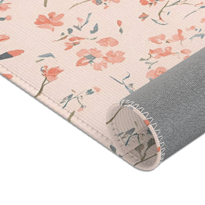 Nursery area rug in a coral, blush and sage palette