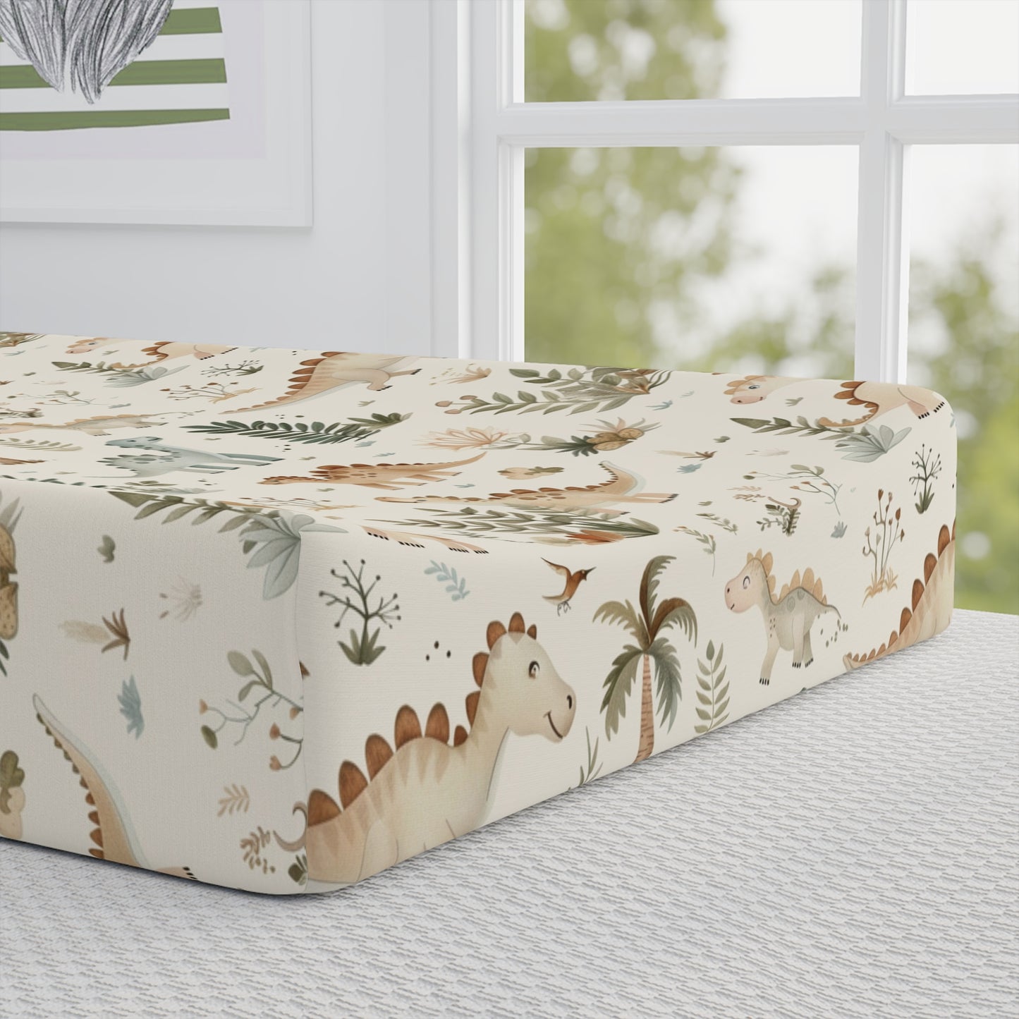 Close detail of the Fern Grove Dinosaurs print on the changing pad cover