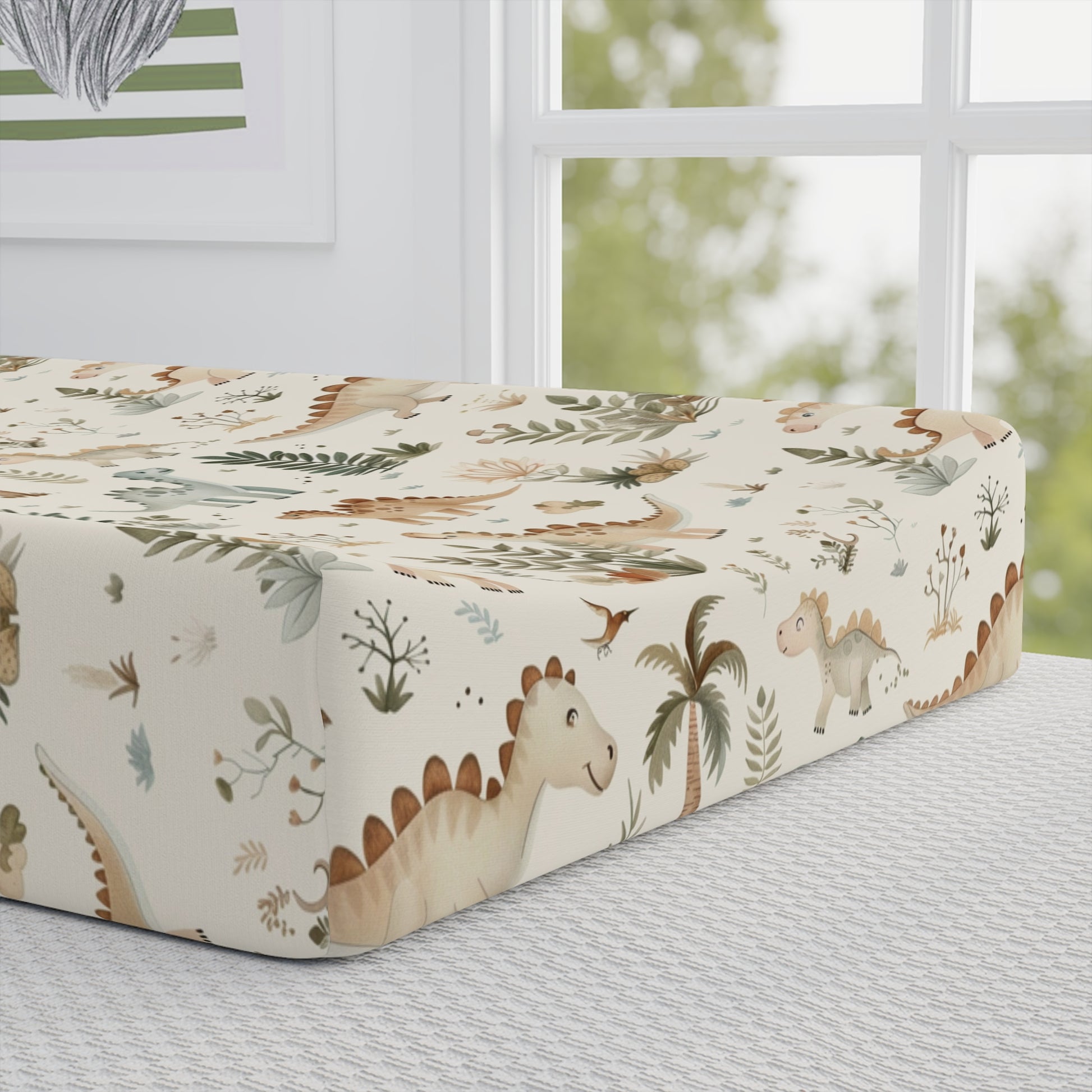 Close detail of the Fern Grove Dinosaurs print on the changing pad cover