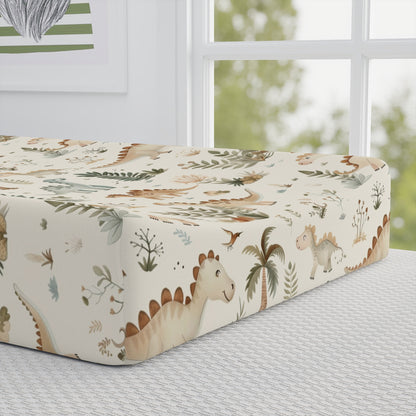 Close detail of the Fern Grove Dinosaurs print on the changing pad cover