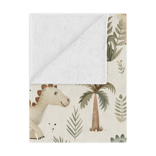 Fern Grove Dinosaurs minky baby blanket draped over a crib
