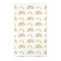 Gold rainbow nursery area rug on a white ground