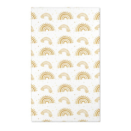 Gold rainbow nursery area rug on a white ground