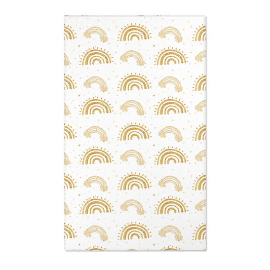 Gold rainbow nursery area rug on a white ground
