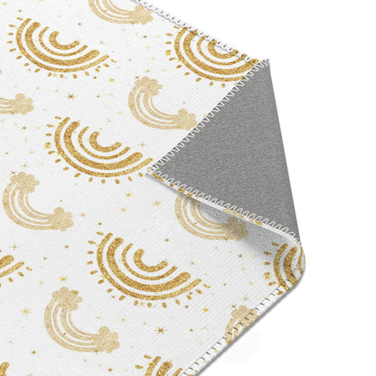 Nursery area rug printed edge to edge with gold rainbows