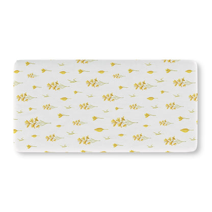 Yellow floral crib sheet on a standard crib mattress