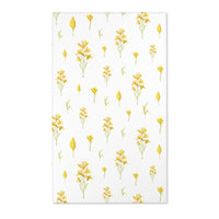 Mustard yellow floral nursery area rug on pale linen