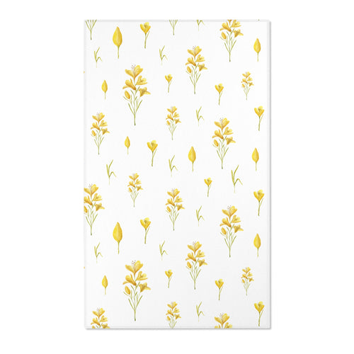 Mustard yellow floral nursery area rug on pale linen