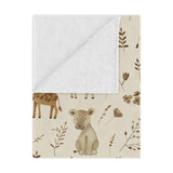 Golden Savanna minky baby blanket draped over a crib